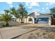View of the home's exterior with a driveway, beautiful rock landscaping, and a blue two-car garage at 2253 S Emerson --, Mesa, AZ 85210