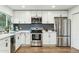 Modern kitchen boasts stainless appliances, white cabinets, and stylish mosaic backsplash at 2253 S Emerson --, Mesa, AZ 85210
