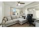 Cozy living room with a sectional couch, desk, and shelving perfect for working from home at 2253 S Emerson --, Mesa, AZ 85210