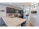 Well-lit kitchen featuring stainless steel appliances, dark cabinetry, and a spacious countertop island with a double sink at 2573 S Powell Rd, Apache Junction, AZ 85119