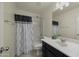 Bathroom featuring a shower-tub combination, white vanity, and modern mirror at 29031 N 125Th Ln, Peoria, AZ 85383