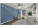 Bedroom featuring a blue accent wall, white furniture, and a large window at 29031 N 125Th Ln, Peoria, AZ 85383