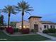 Exterior of home featuring lush landscaping, desert trees, and stone accent tower at 29031 N 125Th Ln, Peoria, AZ 85383