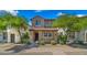 Charming two-story home with a tile roof, a covered porch and landscaped front yard at 29031 N 125Th Ln, Peoria, AZ 85383