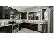 Modern kitchen features granite countertops, stainless steel appliances, and dark wood cabinets at 29031 N 125Th Ln, Peoria, AZ 85383
