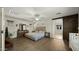 Spacious main bedroom with a barn door to en-suite bathroom and luxury vinyl plank flooring at 29031 N 125Th Ln, Peoria, AZ 85383