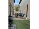 Inviting patio with a round table, chairs, and artificial turf, perfect for outdoor gatherings under string lights at 29031 N 125Th Ln, Peoria, AZ 85383