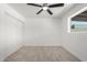 Bedroom with a ceiling fan, window, light colored wood-look flooring and sliding closet doors at 3029 W Windrose Dr, Phoenix, AZ 85029