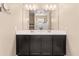 Well-lit bathroom features a dual sink vanity, large mirror, and a glass shower at 30382 W Vale Dr, Buckeye, AZ 85396