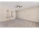 Open bedroom has neutral walls, carpet flooring, ceiling fan, and closet space at 30382 W Vale Dr, Buckeye, AZ 85396