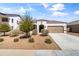 Charming single-story home with a well-maintained front yard, two car garage and terracotta colored roof tiles at 30382 W Vale Dr, Buckeye, AZ 85396