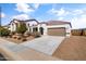 Charming single-story home with a well-maintained front yard, two car garage and terracotta colored roof tiles at 30382 W Vale Dr, Buckeye, AZ 85396
