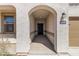 Covered front entrance features an arched entryway and a dark front door with the house number clearly displayed at 30382 W Vale Dr, Buckeye, AZ 85396