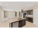 Open kitchen layout features a granite island, stainless steel appliances, and a seamless connection to the living area at 30382 W Vale Dr, Buckeye, AZ 85396