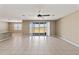 Spacious living room featuring tile flooring, neutral walls, and a sliding glass door offering ample natural light at 30382 W Vale Dr, Buckeye, AZ 85396