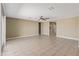Large living room offers neutral paint, tile floors, ceiling fan and backyard access via a sliding glass door at 30382 W Vale Dr, Buckeye, AZ 85396