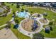 Aerial view of a community playground with splash pad and play structures at 30382 W Vale Dr, Buckeye, AZ 85396