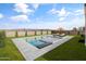 Inviting backyard pool with stylish lounge area, lush green grass, and mountain views at 30382 W Vale Dr, Buckeye, AZ 85396