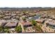 Aerial view of a desert home with tiled roof, landscaping, fire pit seating, and mature trees in a well-planned community at 31525 N Gold Field Rd, San Tan Valley, AZ 85143