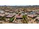 Aerial view of a desert community showcasing tiled roofs, landscaping, and a central home with outdoor fire pit seating at 31525 N Gold Field Rd, San Tan Valley, AZ 85143