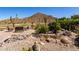 Desert backyard with water feature, mountain views, paver patio and outdoor seating area at 31525 N Gold Field Rd, San Tan Valley, AZ 85143