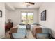 Bright bedroom with twin beds, desert views, and hardwood dresser at 31525 N Gold Field Rd, San Tan Valley, AZ 85143