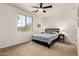 Bedroom with neutral carpet, a dark wooden bed frame, and a large bright window at 31525 N Gold Field Rd, San Tan Valley, AZ 85143