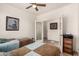 Bright bedroom with twin beds, wood floors, and access to the ensuite bathroom at 31525 N Gold Field Rd, San Tan Valley, AZ 85143