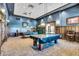 Billiards room with wood paneled walls, carpeted floors, and traditional billiard tables at 31525 N Gold Field Rd, San Tan Valley, AZ 85143