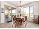 Bright dining area featuring desert views through a large window and sliding glass doors to patio at 31525 N Gold Field Rd, San Tan Valley, AZ 85143