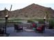 Backyard fire pit with comfortable seating, surrounded by lush greenery and desert landscape, ideal for outdoor gatherings at 31525 N Gold Field Rd, San Tan Valley, AZ 85143