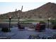 Outdoor fire pit with chairs and decorative lighting, creating a cozy and inviting backyard space for relaxing and socializing at 31525 N Gold Field Rd, San Tan Valley, AZ 85143
