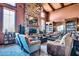 Elegant living room featuring a stone fireplace, coffered ceiling and built-in bookshelves at 31525 N Gold Field Rd, San Tan Valley, AZ 85143