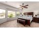 Main bedroom boasts a decorative ceiling fan, and bright windows with scenic desert views at 31525 N Gold Field Rd, San Tan Valley, AZ 85143