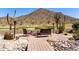 Inviting outdoor seating area with desert landscaping, fire pit, mountain views and a paver patio at 31525 N Gold Field Rd, San Tan Valley, AZ 85143