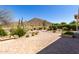 Expansive paver patio with mountain views, desert landscaping, and outdoor seating area at 31525 N Gold Field Rd, San Tan Valley, AZ 85143