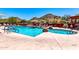 Community swimming pool and hot tub with lounge chairs and mountain views in background at 31525 N Gold Field Rd, San Tan Valley, AZ 85143