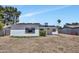 The home's backyard features low maintenance ground cover, a covered patio, and privacy fencing at 3517 E Hartford Ave, Phoenix, AZ 85032