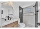 Sleek bathroom featuring modern fixtures, a tiled shower with a glass enclosure, and neutral wall paint at 3517 E Hartford Ave, Phoenix, AZ 85032