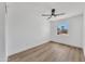 Empty bedroom featuring a ceiling fan, hardwood floors, and a sunlit window at 3517 E Hartford Ave, Phoenix, AZ 85032