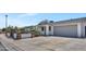 Single-story home with a white exterior, desert landscaping, a gated front yard, and a spacious driveway at 3517 E Hartford Ave, Phoenix, AZ 85032