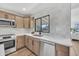 Bright kitchen featuring shaker cabinets, stainless appliances and a window overlooking the backyard at 3517 E Hartford Ave, Phoenix, AZ 85032