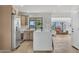Open kitchen with an island, stainless steel appliances, modern cabinets, and tile backsplash at 3517 E Hartford Ave, Phoenix, AZ 85032