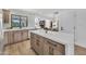 Modern kitchen with an island, wooden cabinets, stone countertops, and stainless steel appliances at 3517 E Hartford Ave, Phoenix, AZ 85032