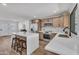 Open kitchen with white countertops, stainless appliances, shaker cabinets, and a large island with seating at 3517 E Hartford Ave, Phoenix, AZ 85032