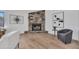 Living room showcasing a stone fireplace, gray arm chair and modern decor at 3517 E Hartford Ave, Phoenix, AZ 85032