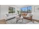 Inviting living room with large windows, comfortable seating, and stylish decor at 3517 E Hartford Ave, Phoenix, AZ 85032