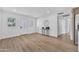 Bright living room with wood-look floors, modern decor, and freshly painted white walls at 3517 E Hartford Ave, Phoenix, AZ 85032
