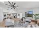 Open-concept living room with modern furnishings, a ceiling fan, and seamless access to dining and kitchen areas at 3517 E Hartford Ave, Phoenix, AZ 85032