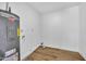 Clean utility room features Rheem water heater and durable wood-look flooring at 3517 E Hartford Ave, Phoenix, AZ 85032